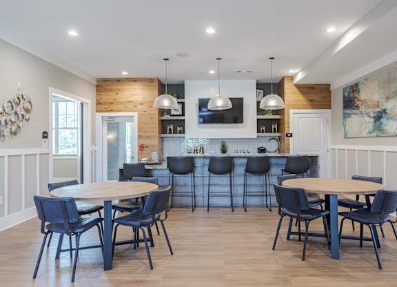 A modern kitchen with a wooden island and bar stools.
