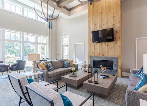 A living room with a fireplace and a television mounted on the wall.