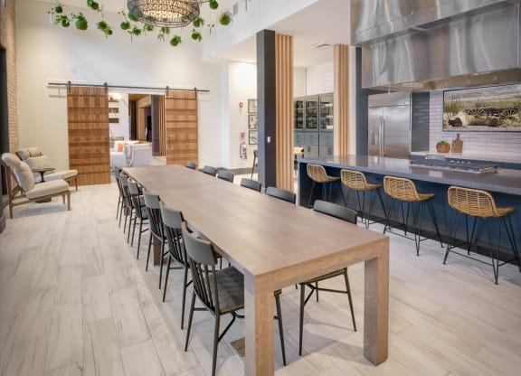 a dining room with a long wooden table and chairs