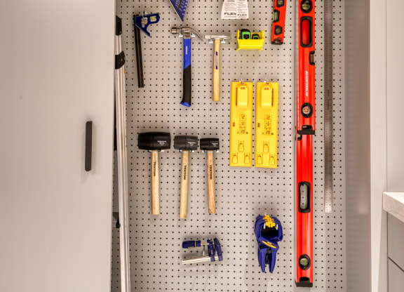 a pegboard wall in a kitchen with tools on it