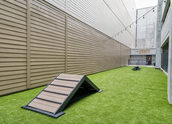 a ramp on the side of a building with grass
