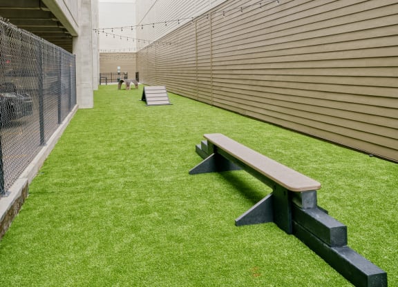a courtyard with a bench and a fence