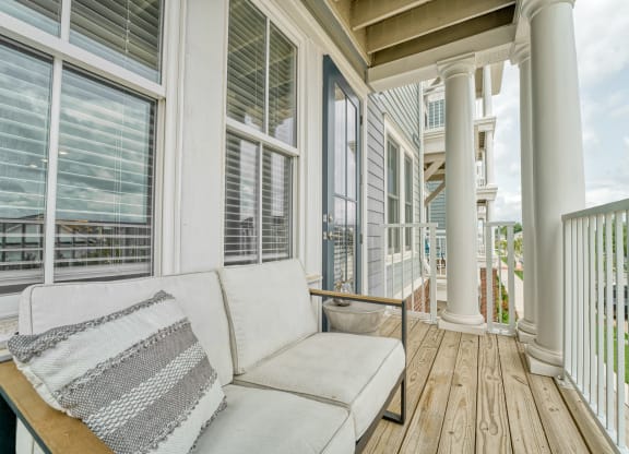 a porch with a couch and many windows