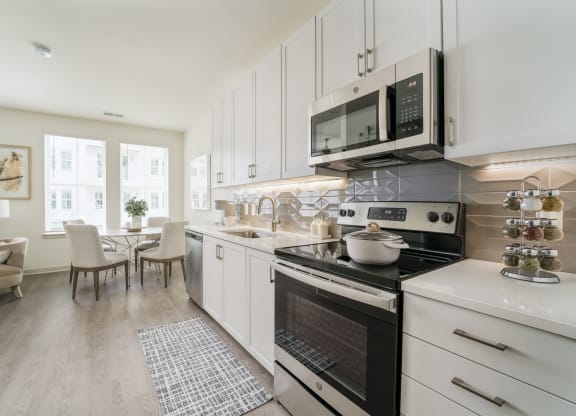 a kitchen and dining room with pink and white walls
