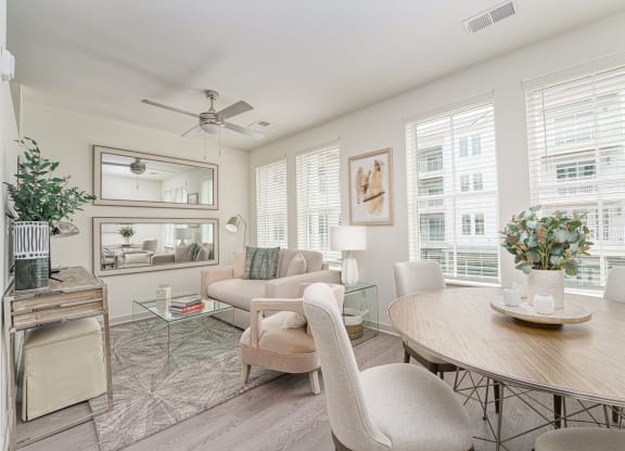 a living room with a round dining table and a couch