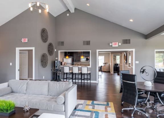 a living room with gray walls and a vaulted ceiling at Misty Ridge Apartments, Woodbridge
