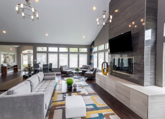 a large living room with a large fireplace and a large tv on the wall at Misty Ridge Apartments, Woodbridge Virginia