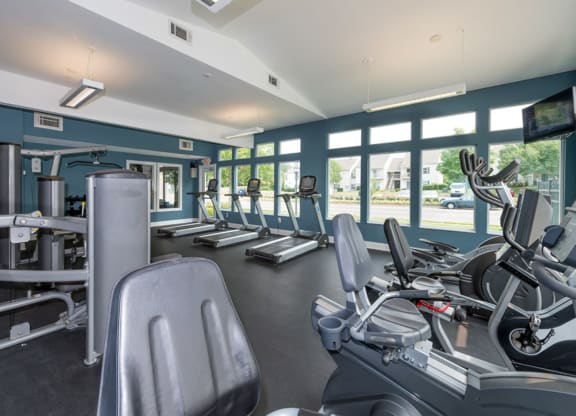 a gym with cardio equipment and windows at Misty Ridge Apartments, Woodbridge, 22191