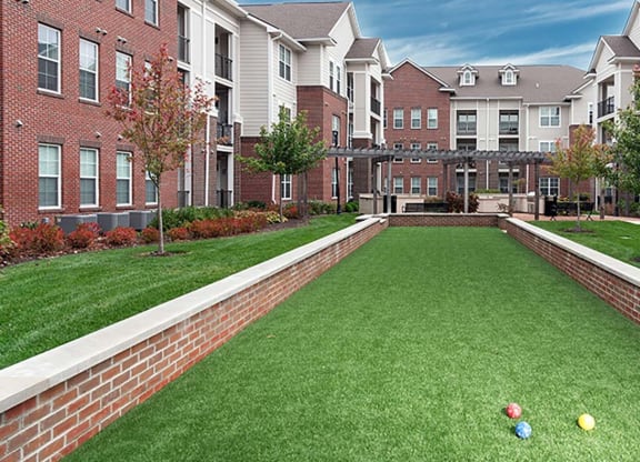 a bocce court in front of an apartment building at Canopy at Ginter Park Apartments, Richmond, VA, 23227