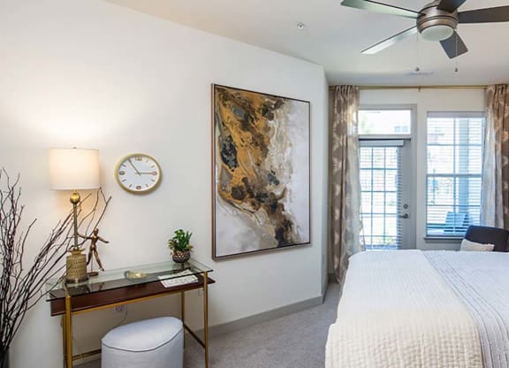 a bedroom with a bed and a ceiling fan at Canopy at Ginter Park Apartments in Richmond, VA