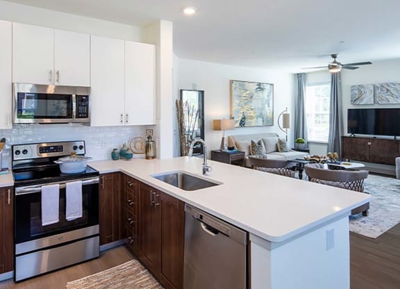 a kitchen with white cabinets and a white counter top at Canopy at Ginter Park Apartments in Virginia 23227