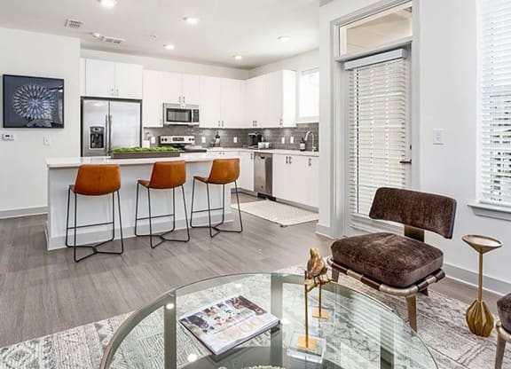 a kitchen and living room with a table and chairs at Canopy at Ginter Park Apartments in VA 23227