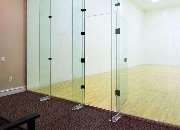 A room with a wooden floor and glass walls at Austin Chase Apartments, Georgia 31210