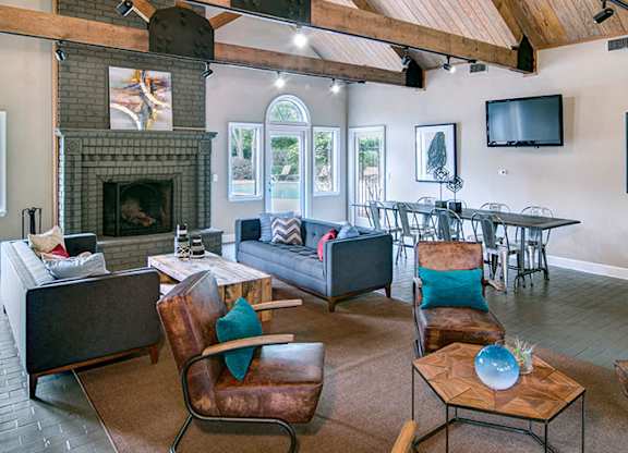 A living room with a fireplace and a television.
