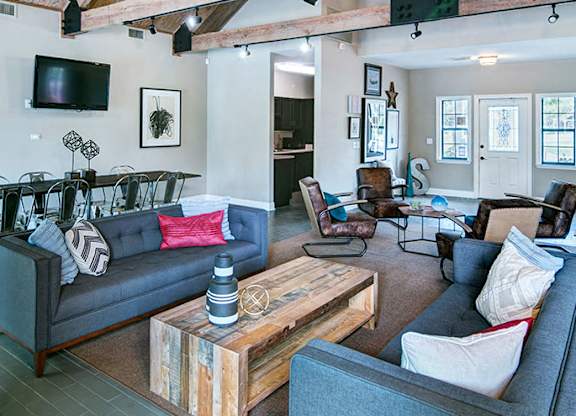 A living room with a grey couch and a wooden coffee table.