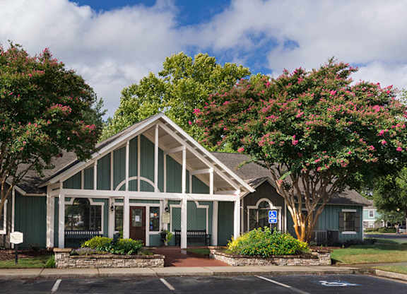 A building with a green roof and white columns.