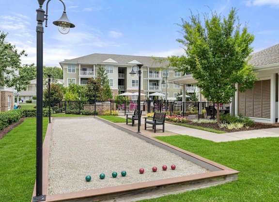 Bocce ball court with poolside seating area at Colony at Centerpointe Apartments, Virginia, 23114