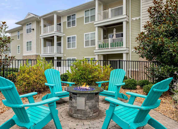 Fire pit seating area with turquoise chairs at Colony at Centerpointe Apartments, Midlothian, VA 23114