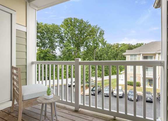 Balcony with seating and tree views at Colony at Centerpointe Apartments, Midlothian, Virginia