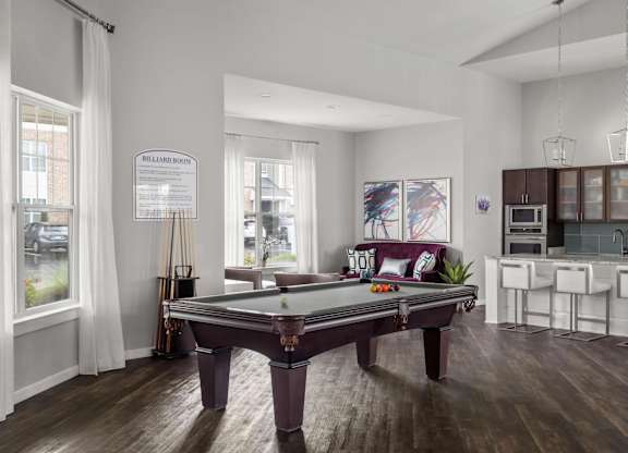 Billiards lounge with pool table and open kitchen at Colony at Centerpointe Apartments, Midlothian, VA