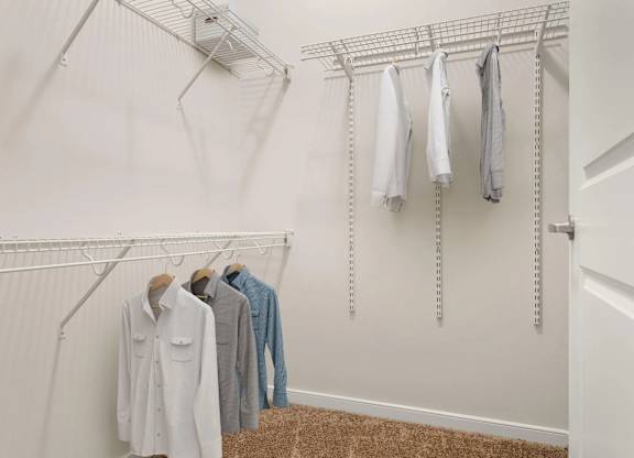 Walk-in closet with wire shelving and hanging rods at Colony at Centerpointe Apartments, Midlothian, 23114
