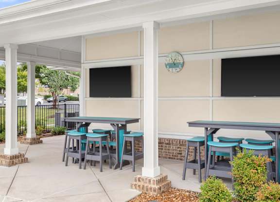 Covered outdoor dining area with wall mounted tvs at Colony at Centerpointe Apartments, Midlothian