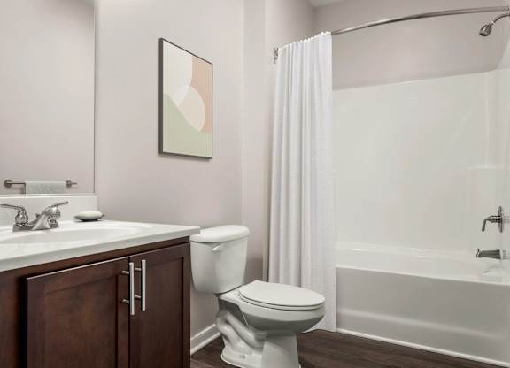 Bathroom with white tub and shower curtain at Colony at Centerpointe Apartments, Midlothian, Virginia