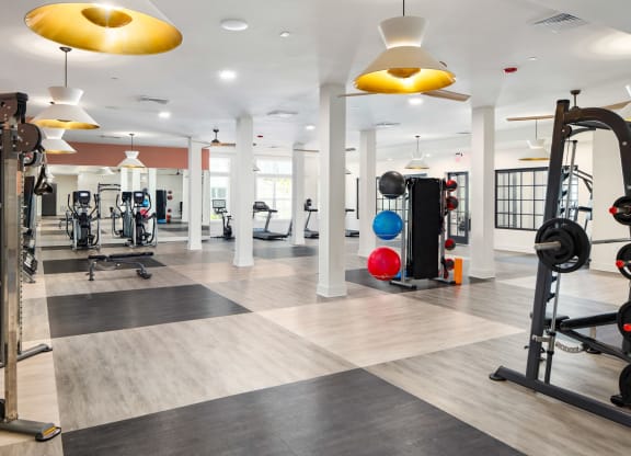 a gym with colorful lights on the ceiling at The Quincy Apartments, Georgia, 30102