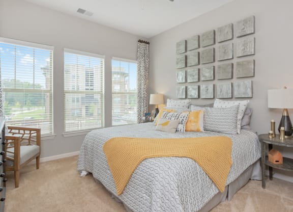 bedroom with yellow blanket at Residence at Riverwatch, Augusta, GA