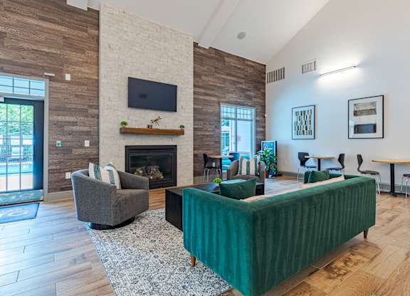 A living room with a fireplace and a green sofa.