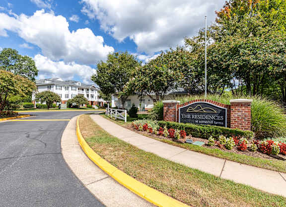 A sign that says "The Residences" is in front of a building.