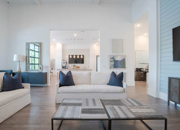 A modern living room with a white couch and a coffee table.