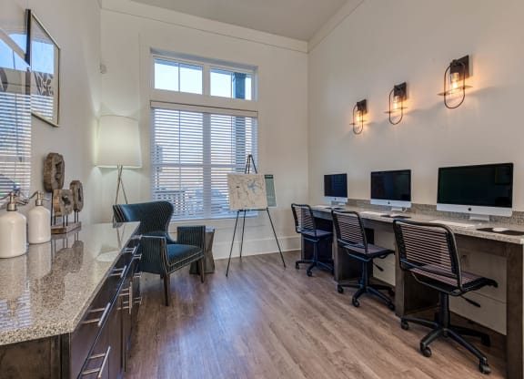 a conference room with desks and chairs and a table with a computer at Retreat at Arden Farms, Arden North Carolina
