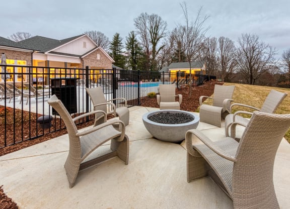a patio with chairs and a fire pit in front of a pool at Retreat at Arden Farms, North Carolina, 28704