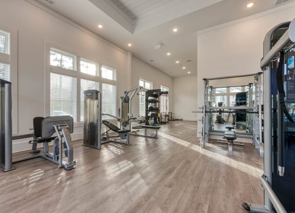 a gym with weights and mirrors on the floor and windows at Retreat at Arden Farms, Arden, NC 28704
