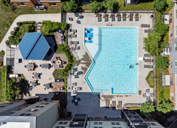 an aerial view of a large swimming pool surrounded by buildings and trees at Rivergate, Virginia, 22191