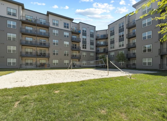 a volleyball court at the flats at big tex apartments in san antonio, tx at Rivergate, Woodbridge, 22191