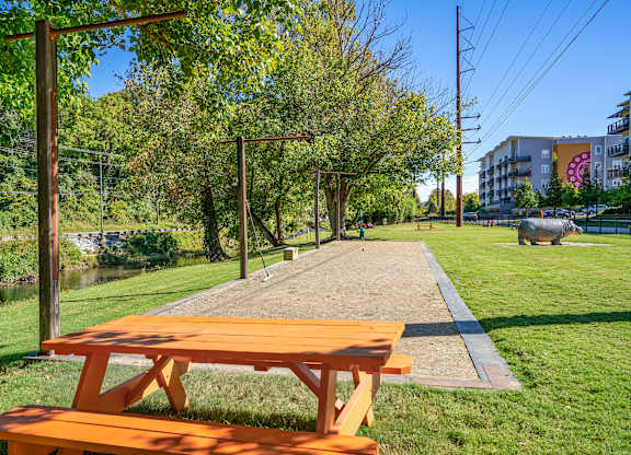 A picnic table sits in the middle of a grassy area.