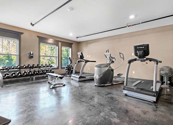 A spacious home gym with a variety of exercise equipment.