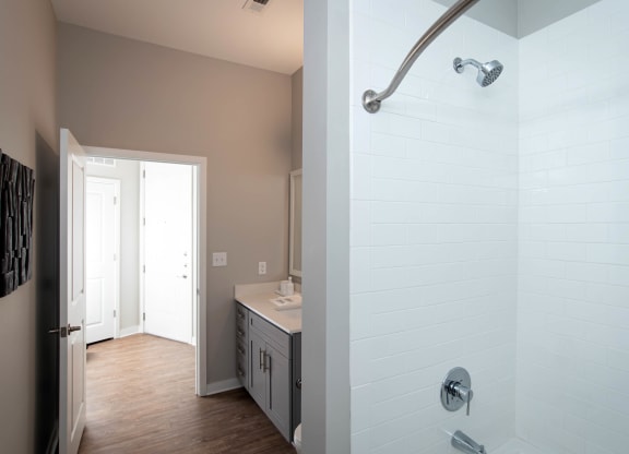 a bathroom with a shower and a sink at One Riverside Apartments, Chattanooga