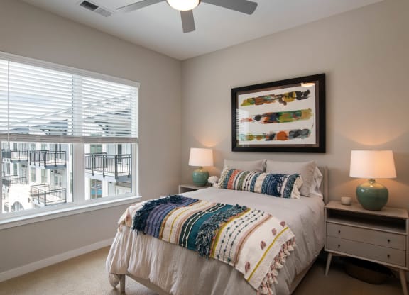 a bedroom with a large window and a bed at One Riverside Apartments, Chattanooga, TN, 37403