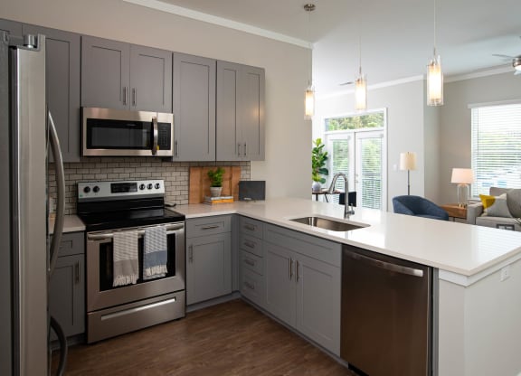 a kitchen with stainless steel appliances and a white counter top at One Riverside Apartments, Chattanooga, 37403