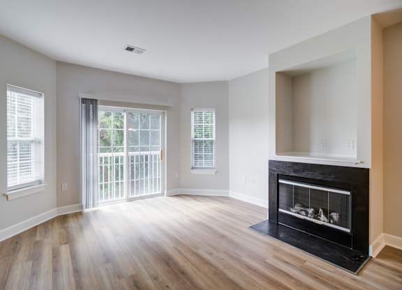 A living room with a fireplace and sliding glass doors.