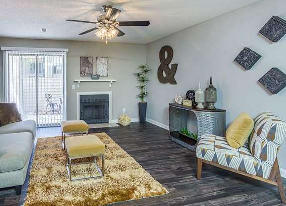 A living room with a fireplace and a couch. at Woodwinds, Aiken