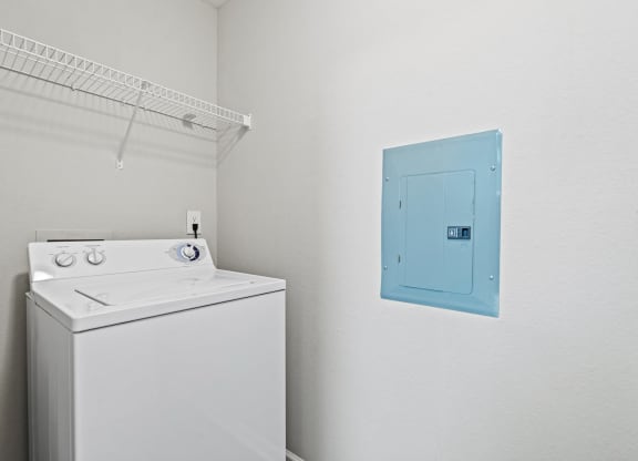 a white washer and dryer in a room with a blue door at SomerHill Farms Apartments, Gainesville, VA 20155