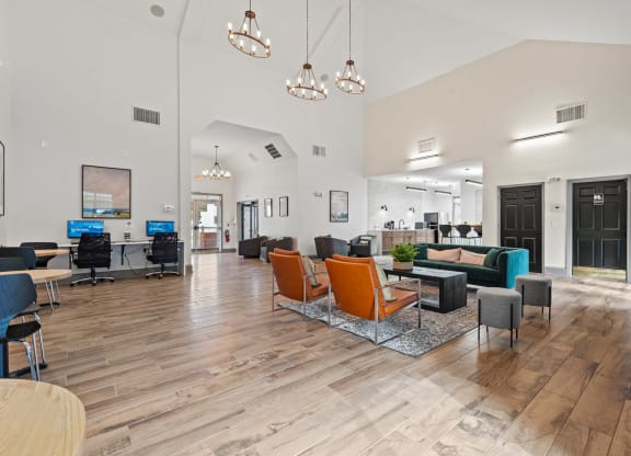 a large lobby with chairs and couches and a reception desk at SomerHill Farms Apartments, Gainesville