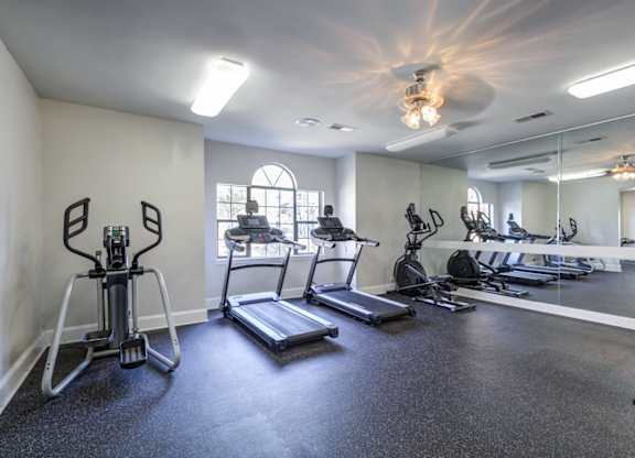 A spacious gym with treadmills, exercise bikes, and other equipment at Southland Station Apartments in Warner Robins, Georgia, 31088