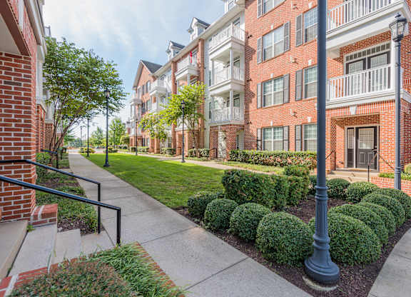 A street view of a residential area with apartment buildings.