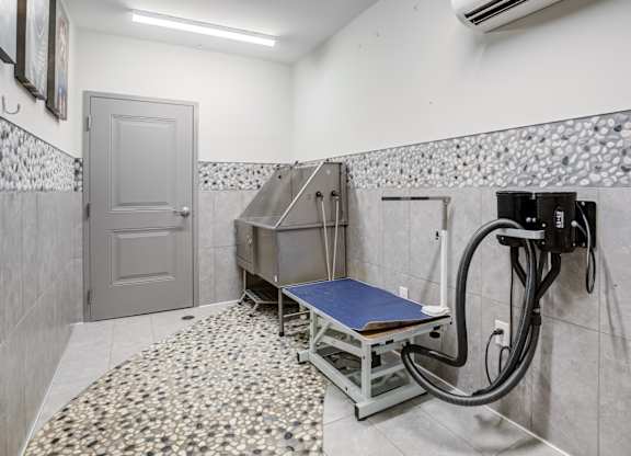 A room with a mosaic tile floor and a bed with a blue mattress.