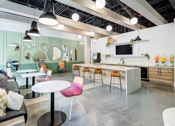 A modern kitchen and dining area with a white table and chairs.